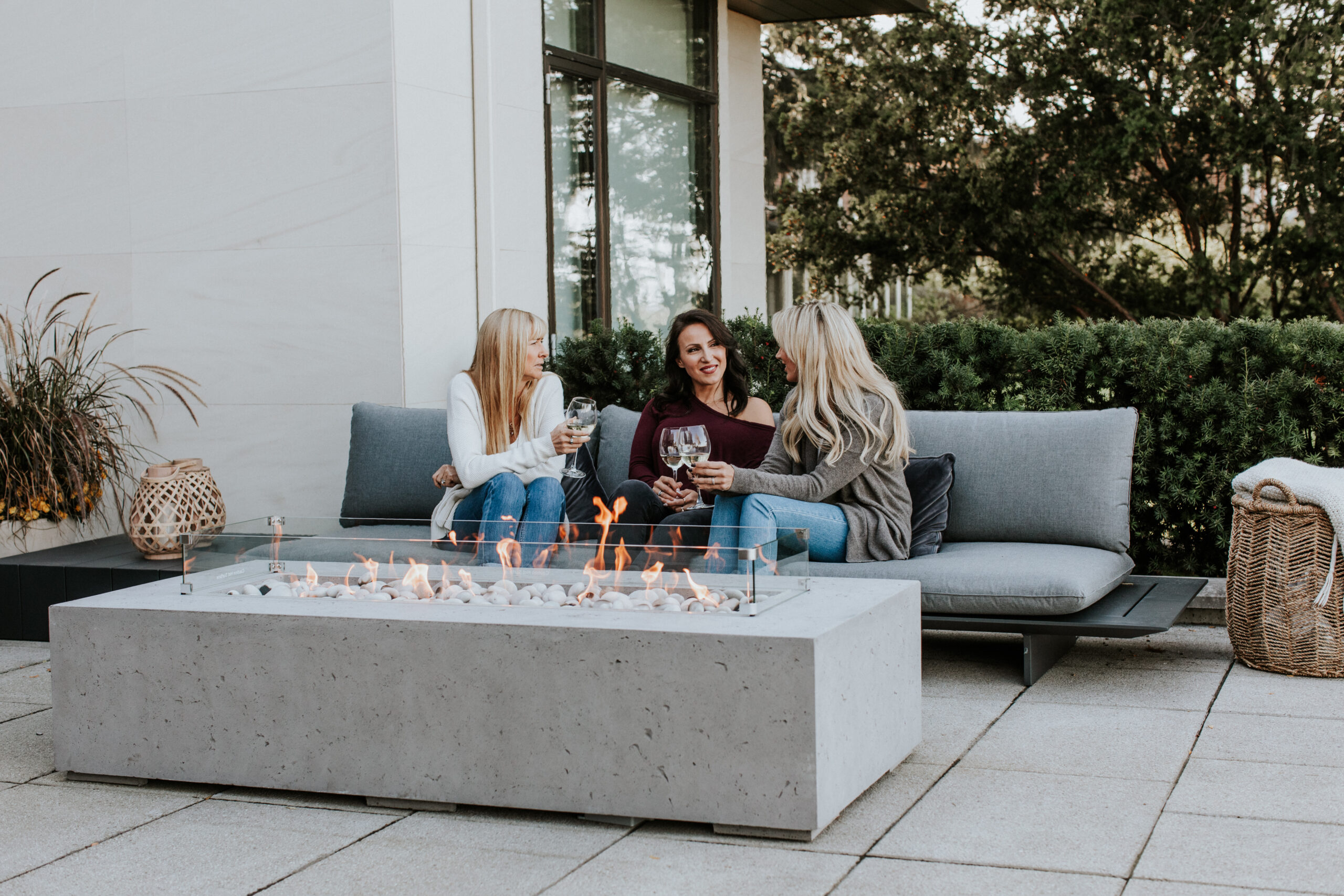 HPC Sono rectangular gas fire table with a linear flame on a backyard patio
