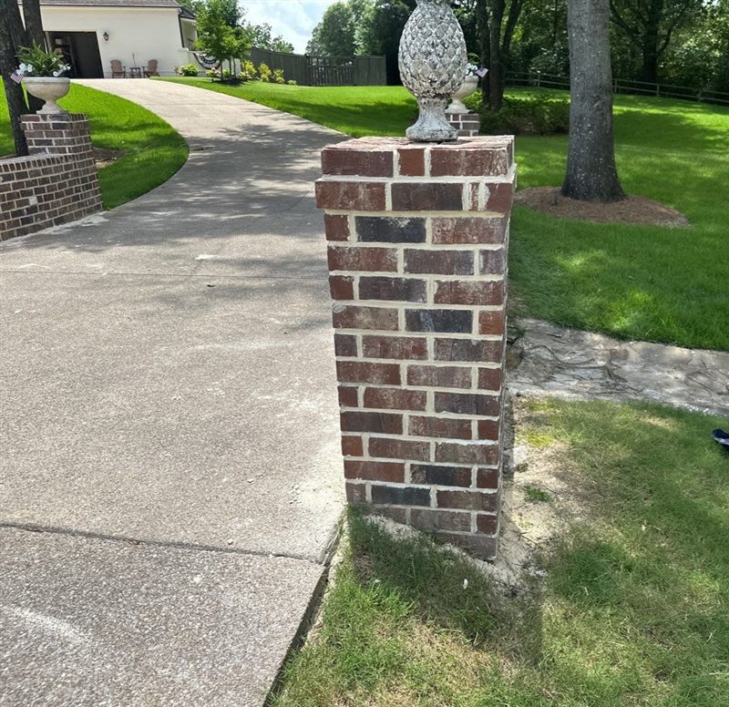 Rebuilt multi-tone brick driveway pier column with clean color-matched mortar joints by Madewell Masonry in Memphis