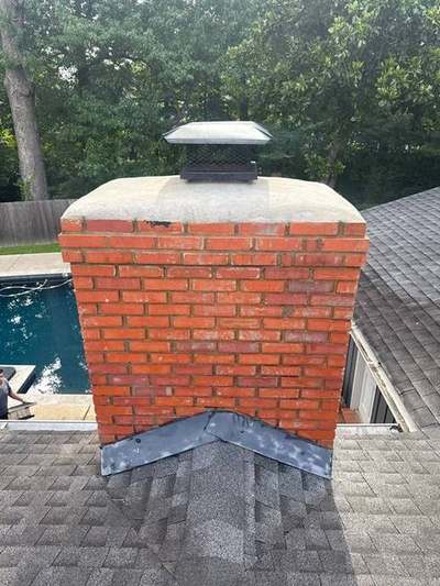 Same chimney finished with poured concrete crown and black stainless cap by Madewell in Memphis