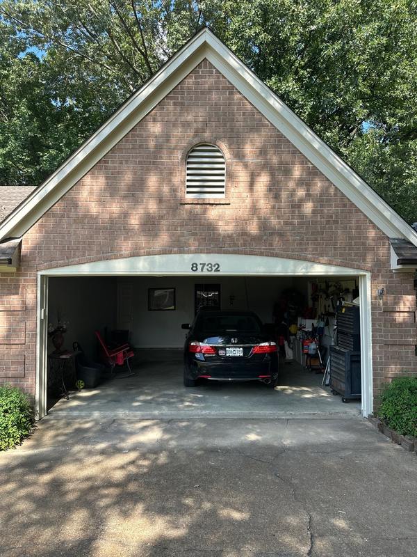 Brick above the garage door rebuilt straight after Madewell lintel repair