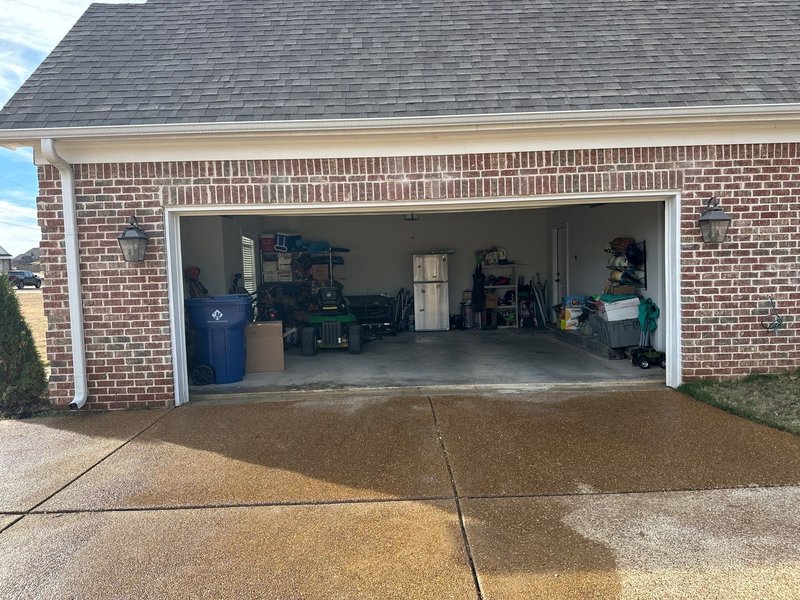 Finished garage door opening with the brick above it rebuilt straight and no shoring or damage visible