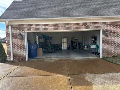 Finished garage door opening with the brick above it rebuilt straight and no shoring or damage visible
