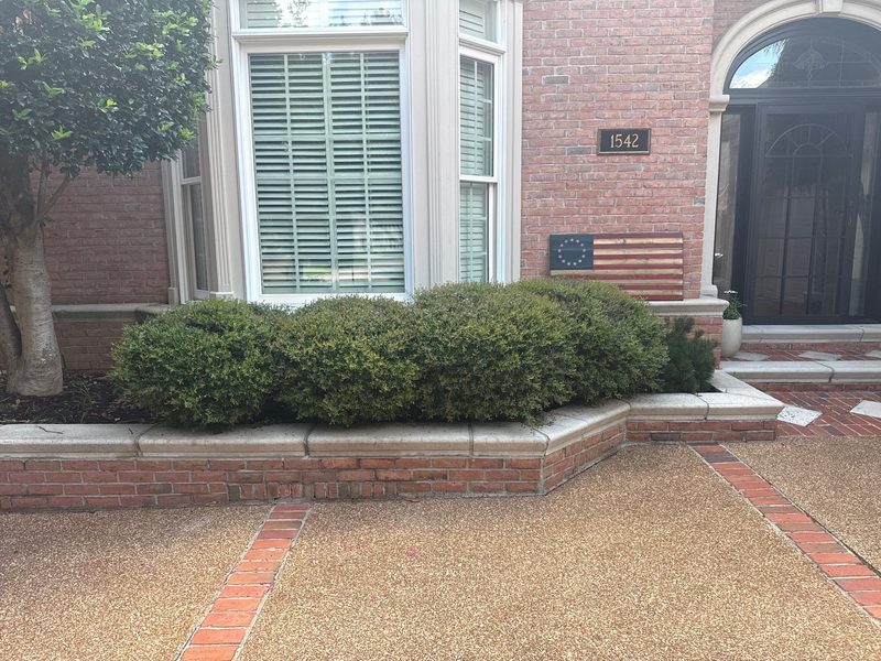 Front-yard brick planter bed and curb before Madewell masonry renovation in Memphis