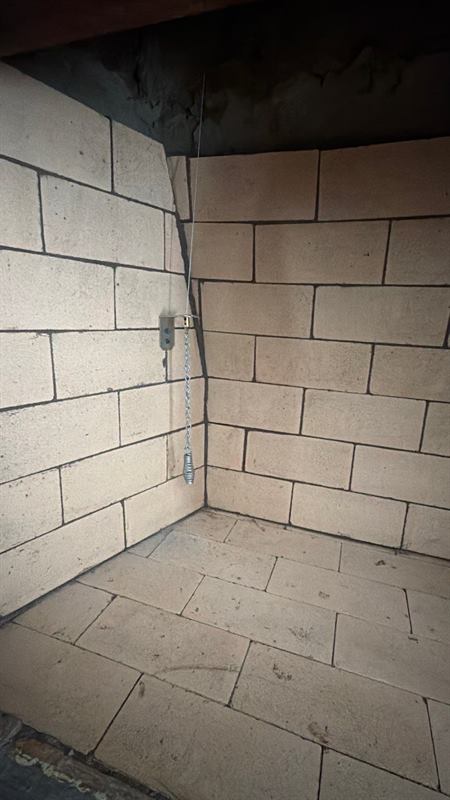 Stainless cable and chain handle mounted in a rebuilt firebox, the hearth control for a top-sealing chimney damper