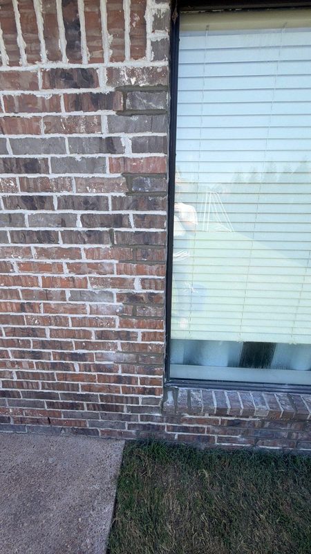 Close view of a rebuilt brick window sill and jamb with new mortar joints at the opening after Madewell leak repair