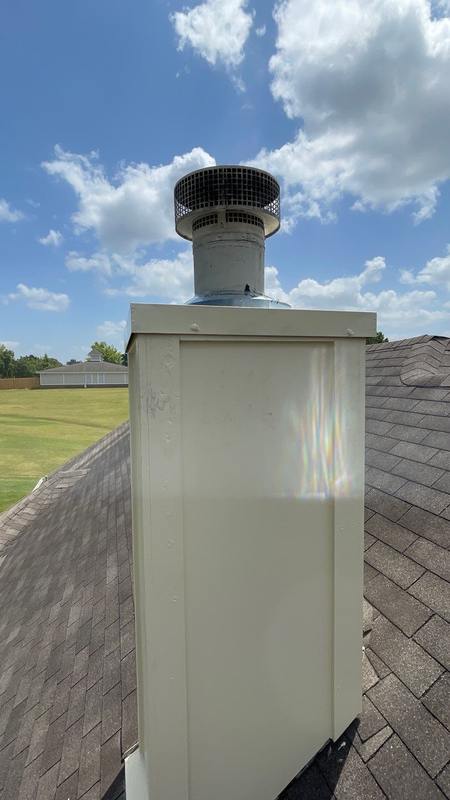 Rebuilt and re-sided wooden chimney chase with a new chase cover after Madewell repair