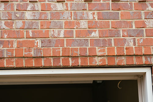 Cracked masonry above garage door 