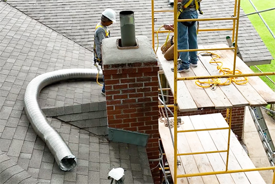 Chimney flashing at base of brick chimney - Madewell Masonry2