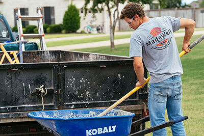 Tech mixing mortar in wheelbarrow