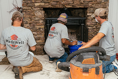 Technicians inspecting fireplace - Madewell Masonry