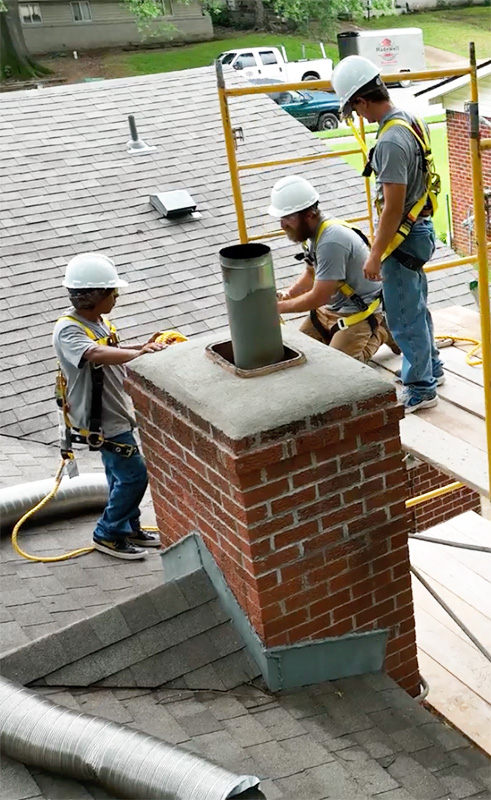 Technicians relining a chimney