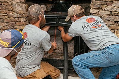 Technicians working on fireplace - Madewell Masonry