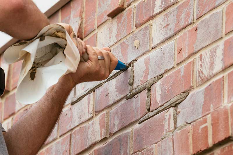 Man applying mortar to bricks